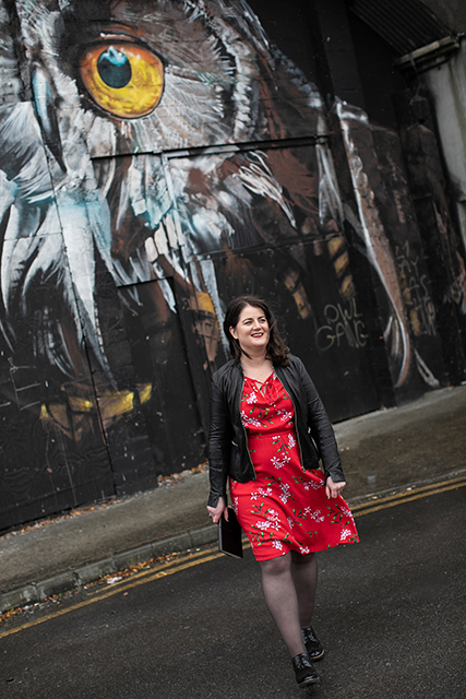 Alison pictured against beautiful Owl wall mural